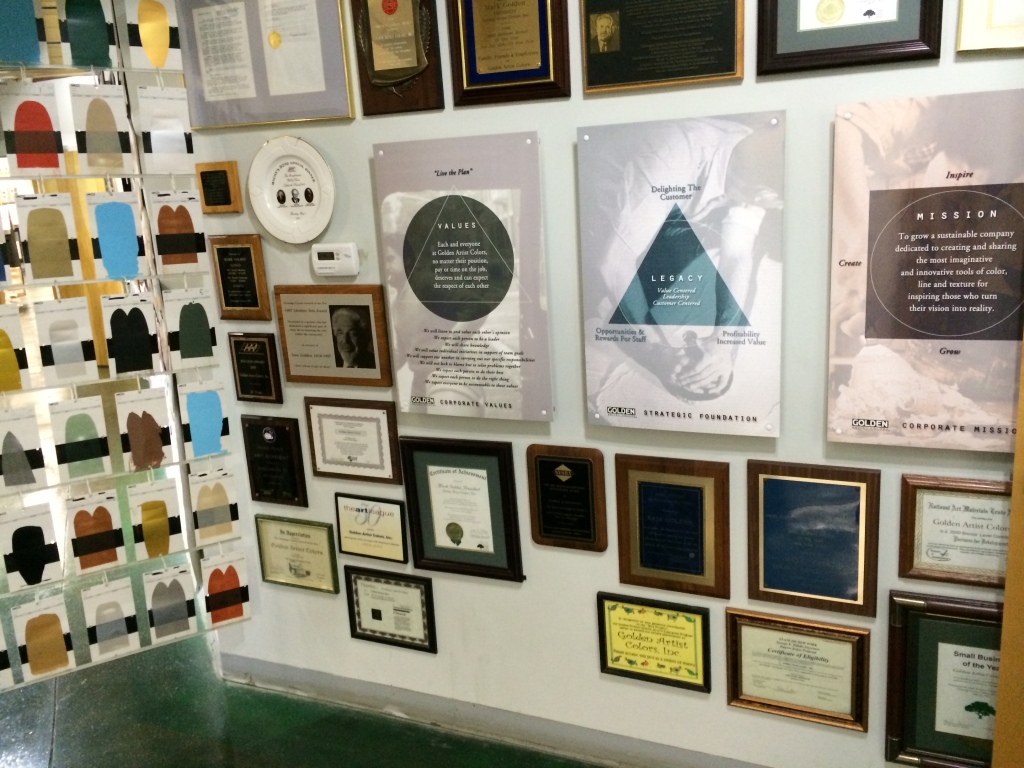 Plaques showing the values, core mission and legacy of Golden Artist Colors. 